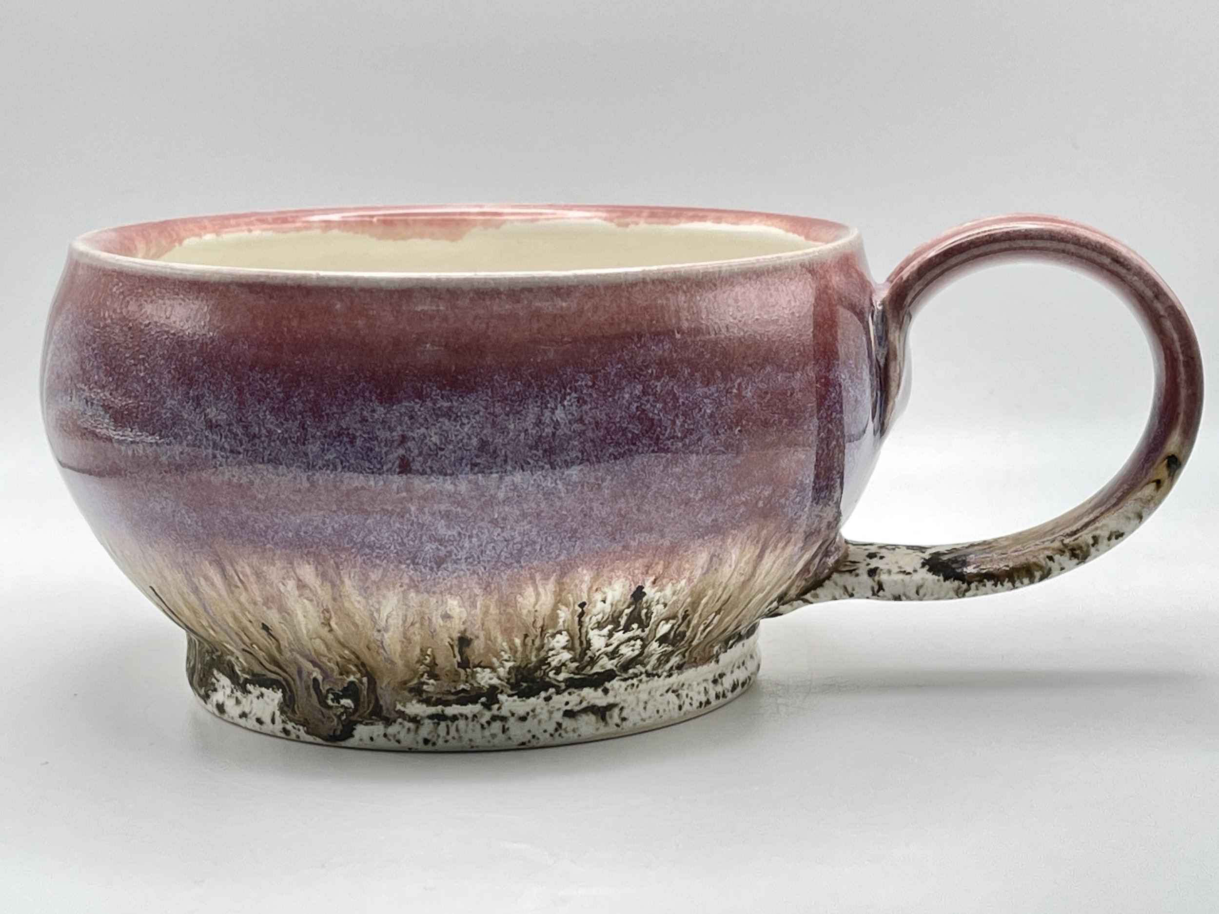 Purple wide bowl mug with speckled bottom and extruded handle